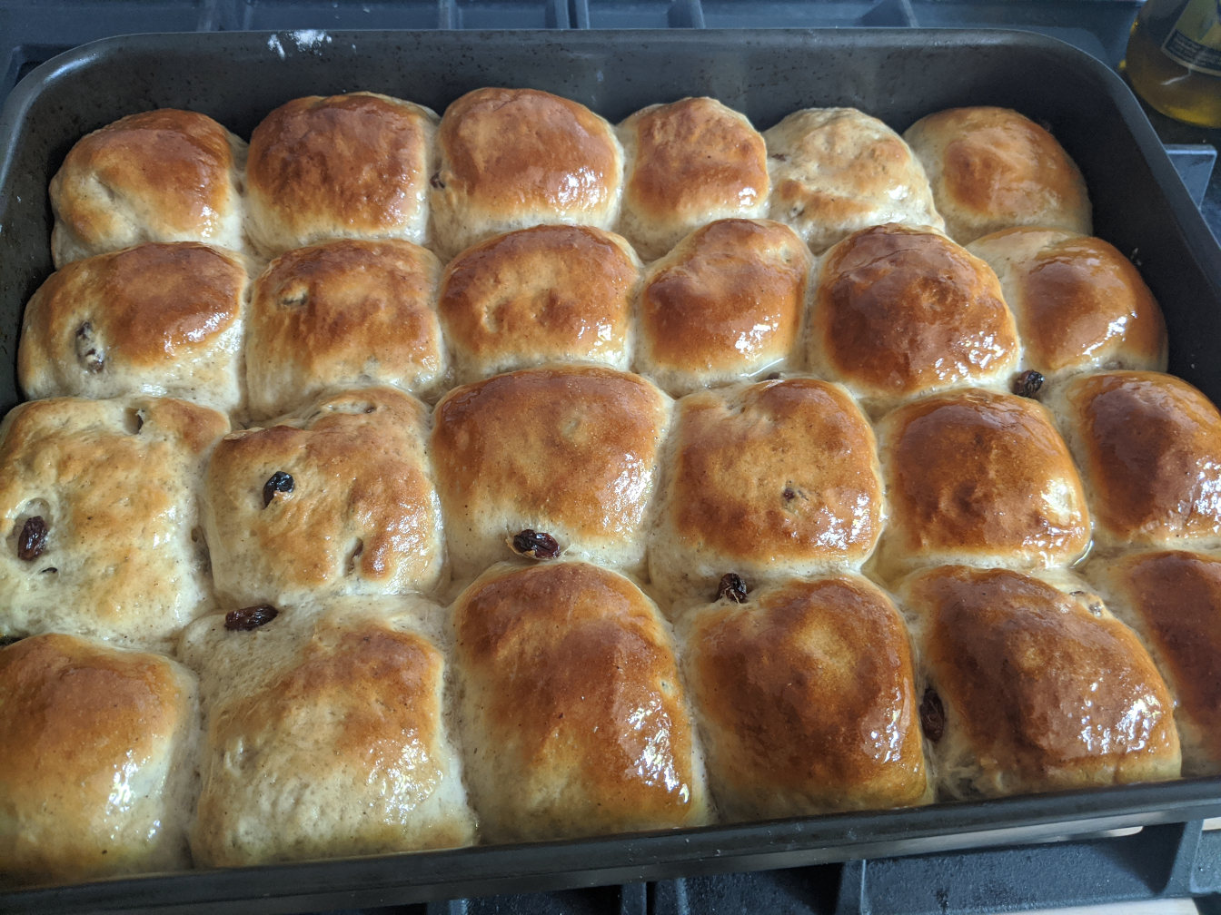 A pan full of fresh hot crossed buns